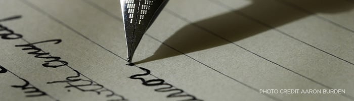 Pen writing on paper.