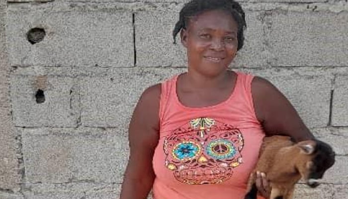 Mother in Haiti smiling for picture.